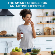 Woman in a kitchen taking TRUEVANTAGE NUTRITION NAC 1000mg vegetarian capsules for cellular health support.
